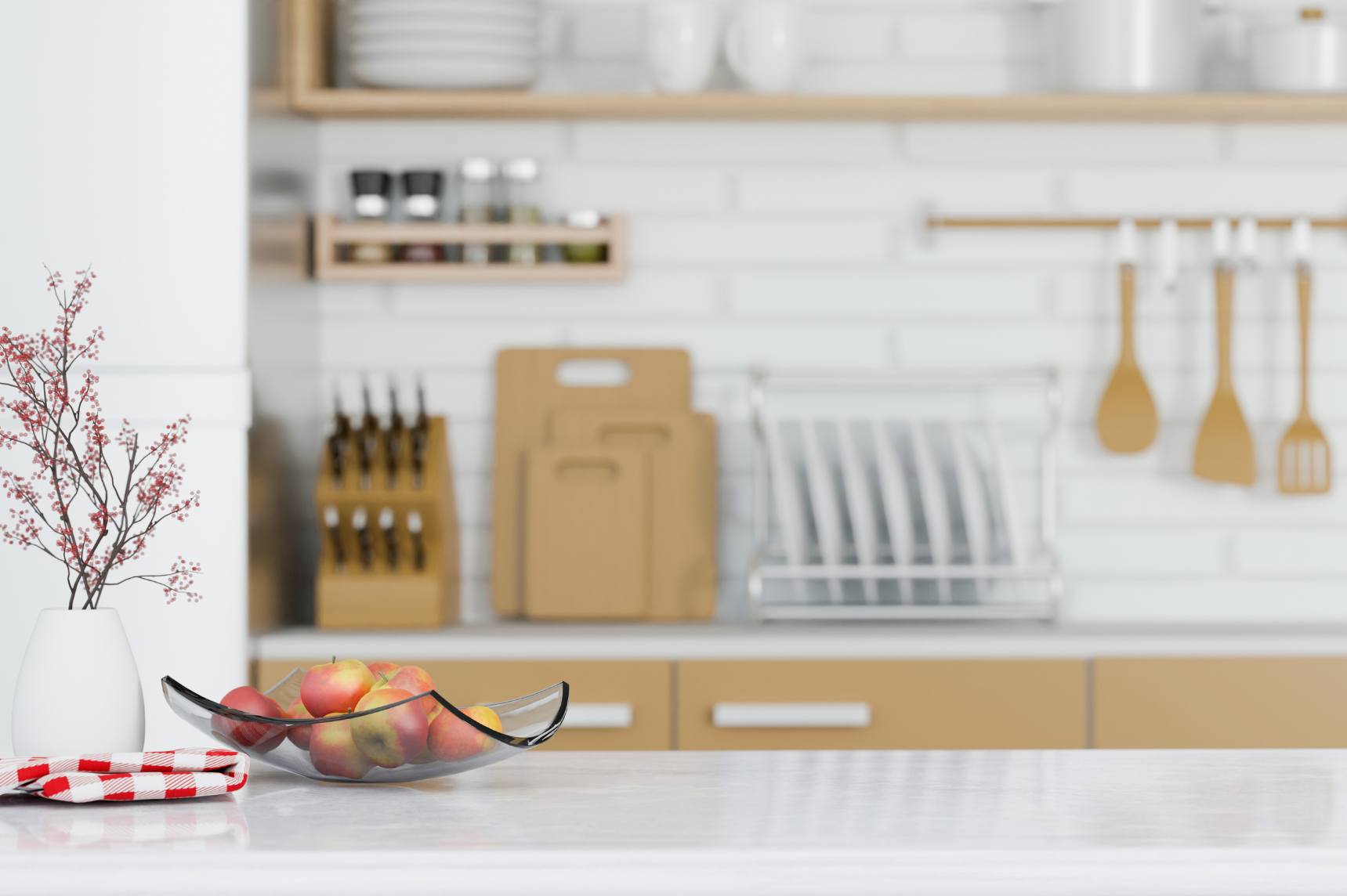 Décor de cuisine avec un bol de fruits sur le plan de travail et des ustensiles à l'arrière-plan