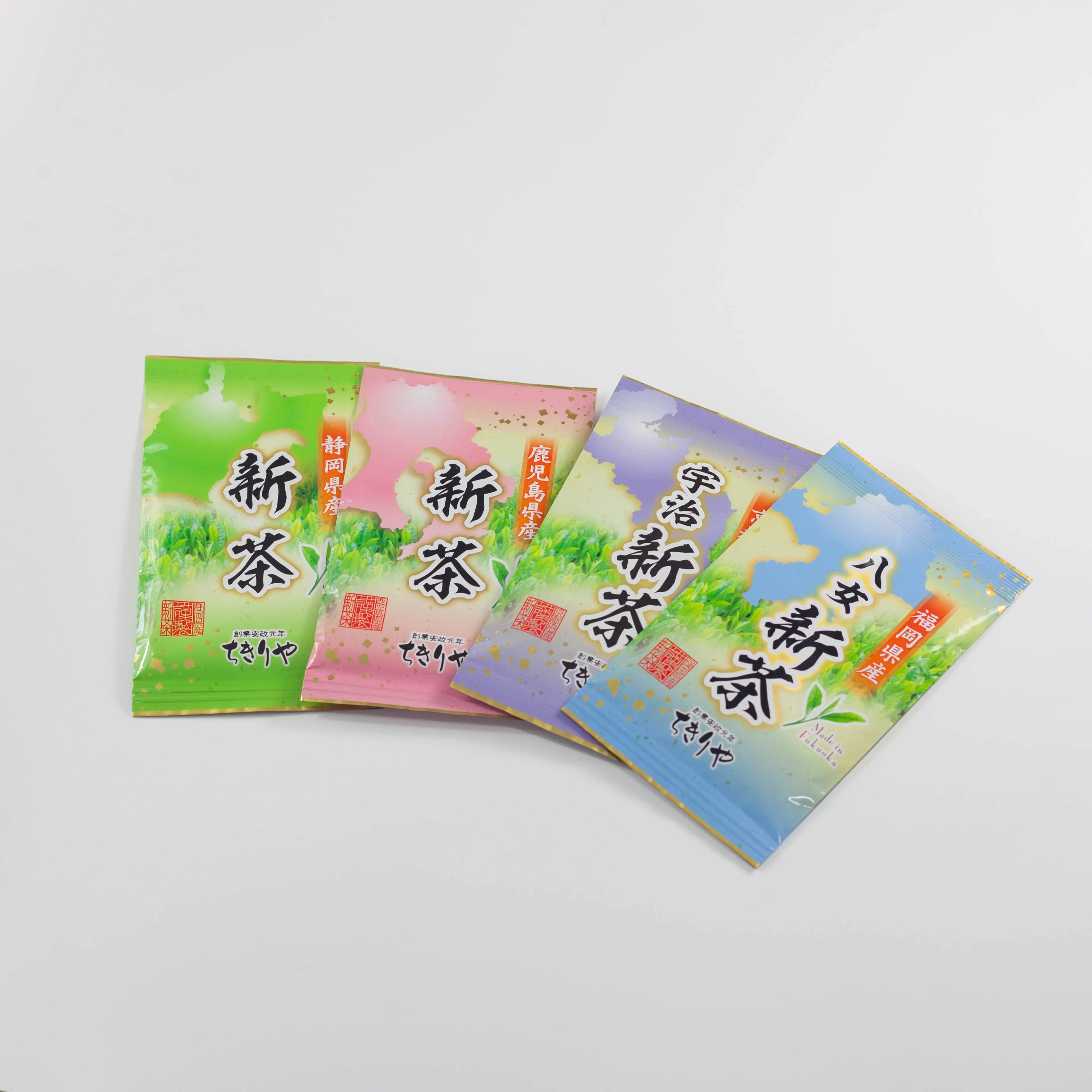 Four bags of seasonal Japanese Shincha green tea from Shizuoka, Kagoshima, Uji, and Yame on a white background